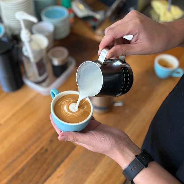 Pouring a flat white at The Town Roaster
