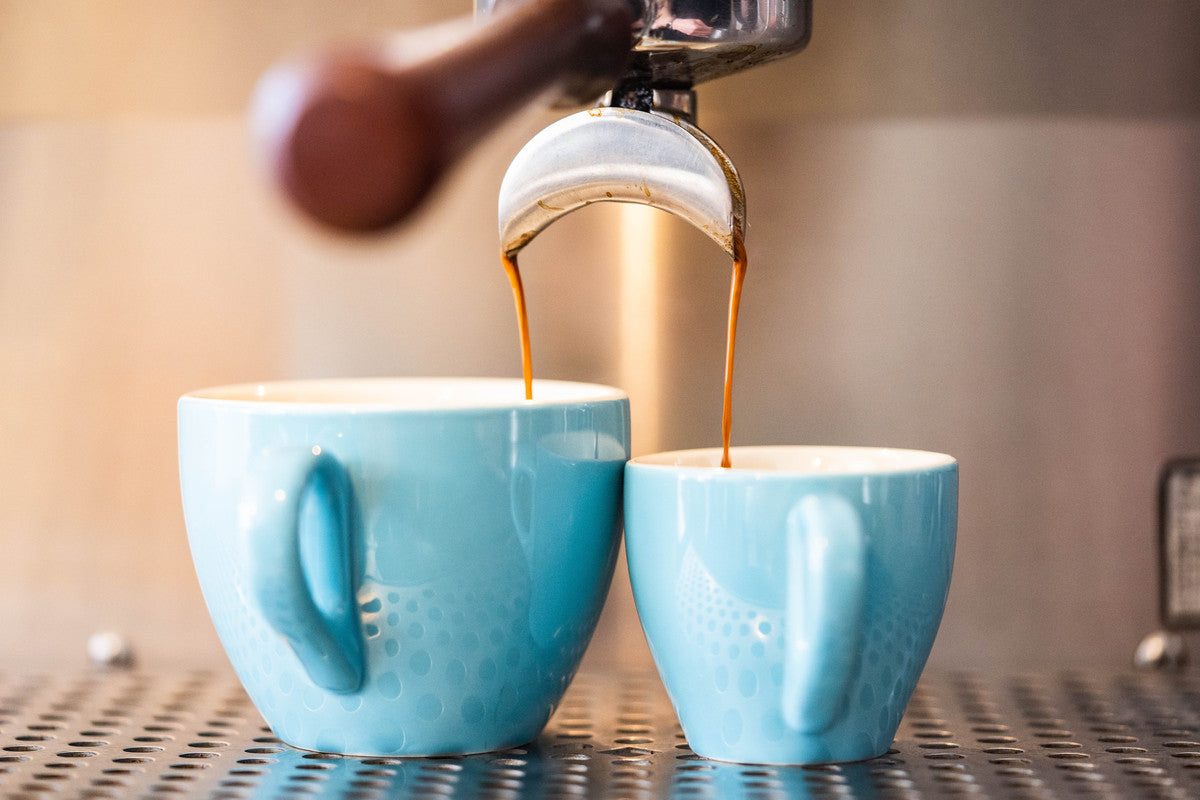 Pouring espresso shots into a cup